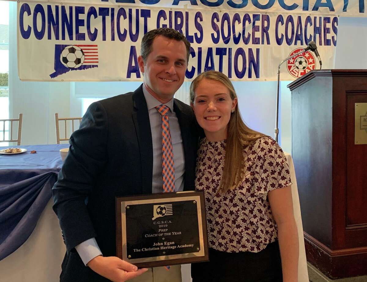 Christian Heritage girls' soccer coach John Egan is joined by Lady Kingsmen junior Jordyn O'Driscoll at the annual Connecticut s Soccer Coaches Association Banquet.