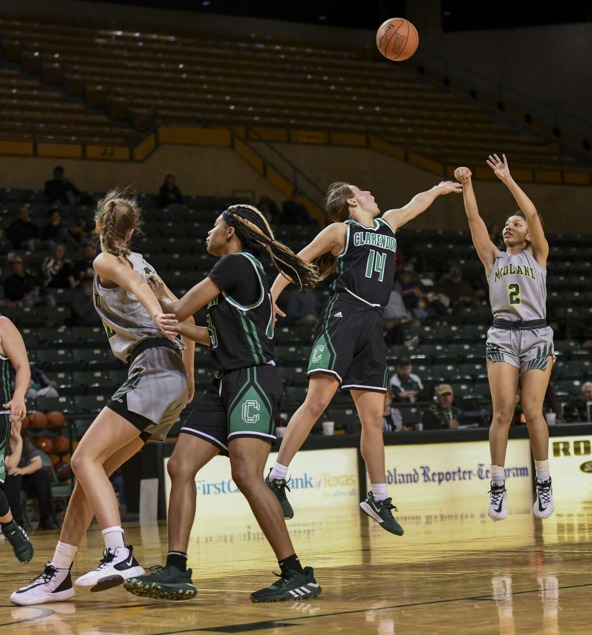 Midland College's Da'Siah Thornton (2) shoots the ball as Clarendon College's Elisa Priddy (14) attempts to block the shot as Midland College's Michaela Kucera and Clarendon College's LyTia Flowers set up for the rebound Thursday, Jan. 23, 2020 at Chaparral Center.
