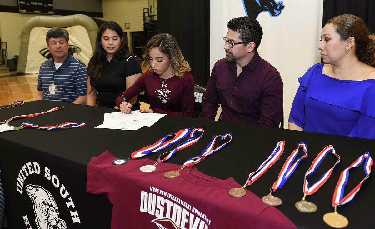 United South cross country runner Julissa Garza is joined by Joe Coronado, Christina Tristan and her parents Johnny Garza and Laura Garza as she signs her National Letter of Intent on Thursday committing to continue her career with TAMIU.