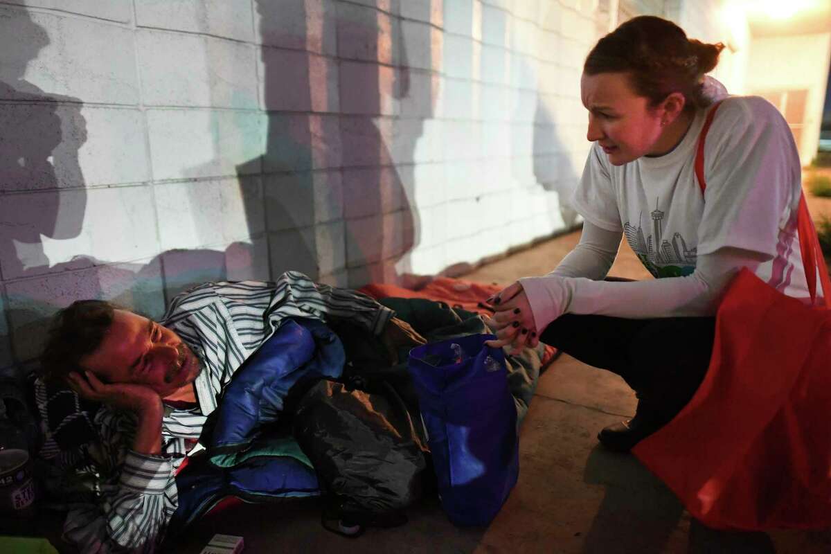 Amanda Sirotzki, a second-year medical student at the University of the Incarnate Word and a member of Street Medicine San Antonio, speaks with Peyton, a homeless man who said that he is suffering from lung cancer, during the annual Point-in-Time Count of the San Antonio area's homeless population on Thursday, Jan. 23, 2020.