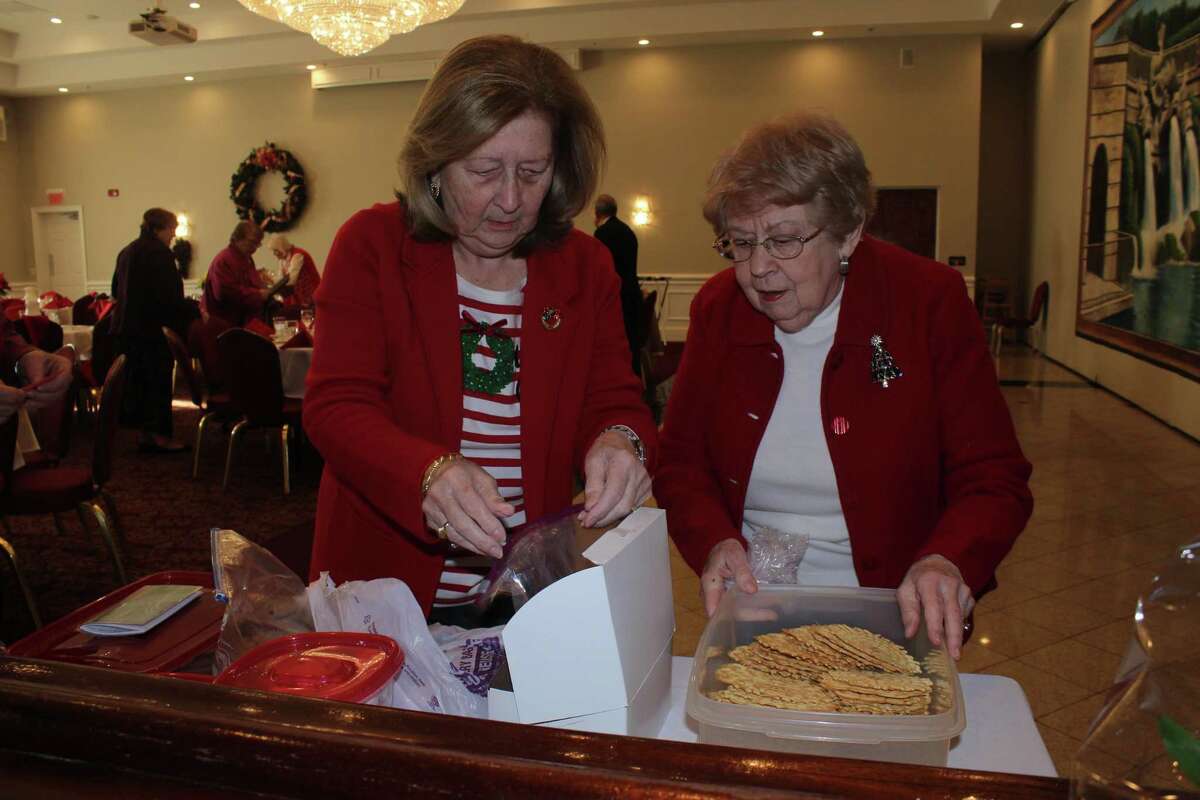 Sandra Petrucelli-Carbone of Oxford and Barbara Kmetz of Trumbull prepare baggies of homemade cookies for the 30 Trumbull High School Chamber Singers who entertained the retired teachers of the Greater Bridgeport Retired Teachers Association (GBRTA) at Testo's Restaurant during the annual December luncheon meeting. Board members had baked the cookies so that the students each had a special holiday snack for the bus ride back to school in Trumbull.