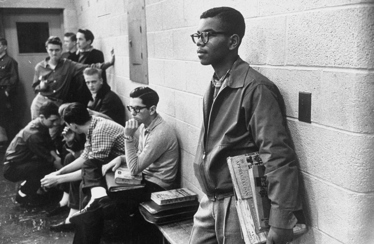 Lewis Cousins (R) only African American student in newly desegregated Maury high school standing alone. (Photo by Paul Schutzer/The LIFE Picture Collection via Getty Images)