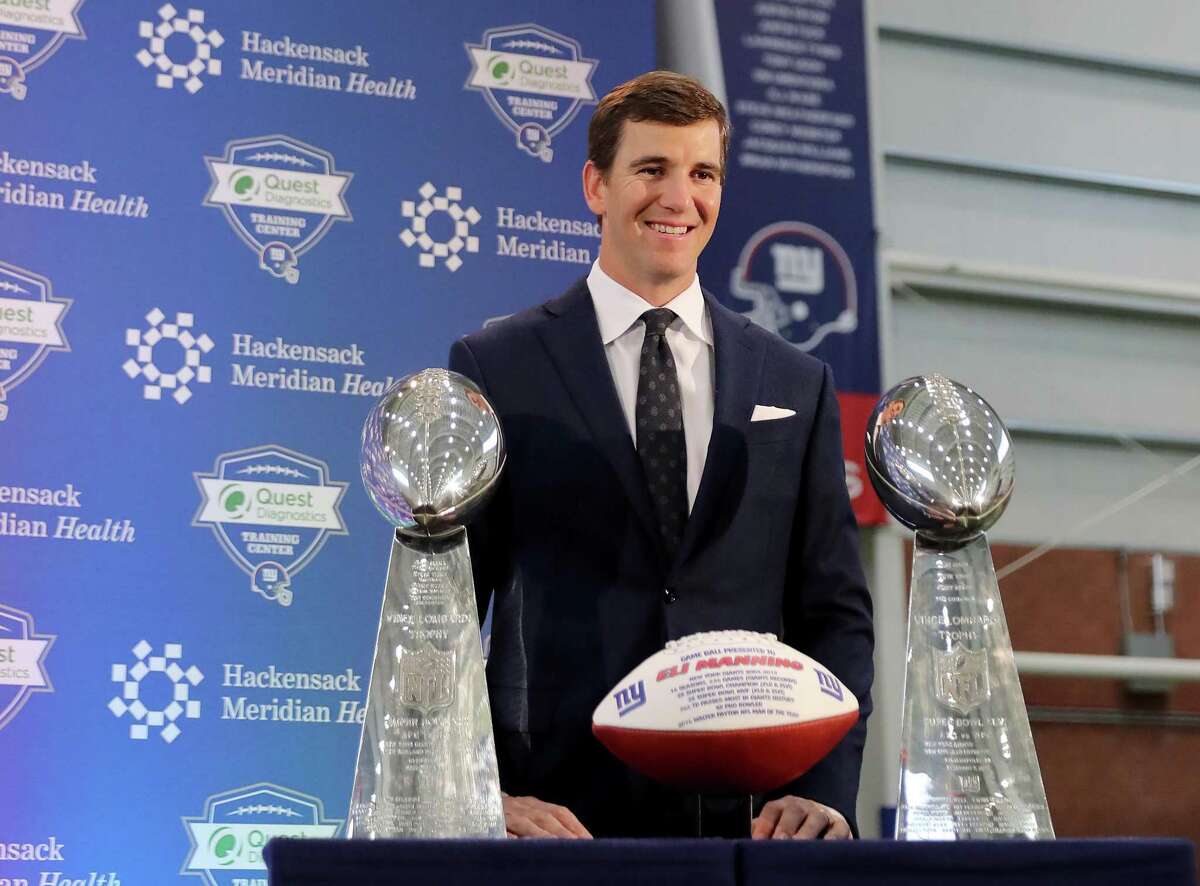 EAST RUTHERFORD, NEW JERSEY - JANUARY 24: Eli Manning of the New York Giants poses with the Vince Lombardi Trophies after a press conference to announce his retirement on January 24, 2020 at Quest Diagnostic Training Center in East Rutherford, New Jersey.The two time Super Bowl MVP is retiring after 16 seasons with the team. (Photo by Elsa/Getty Images)