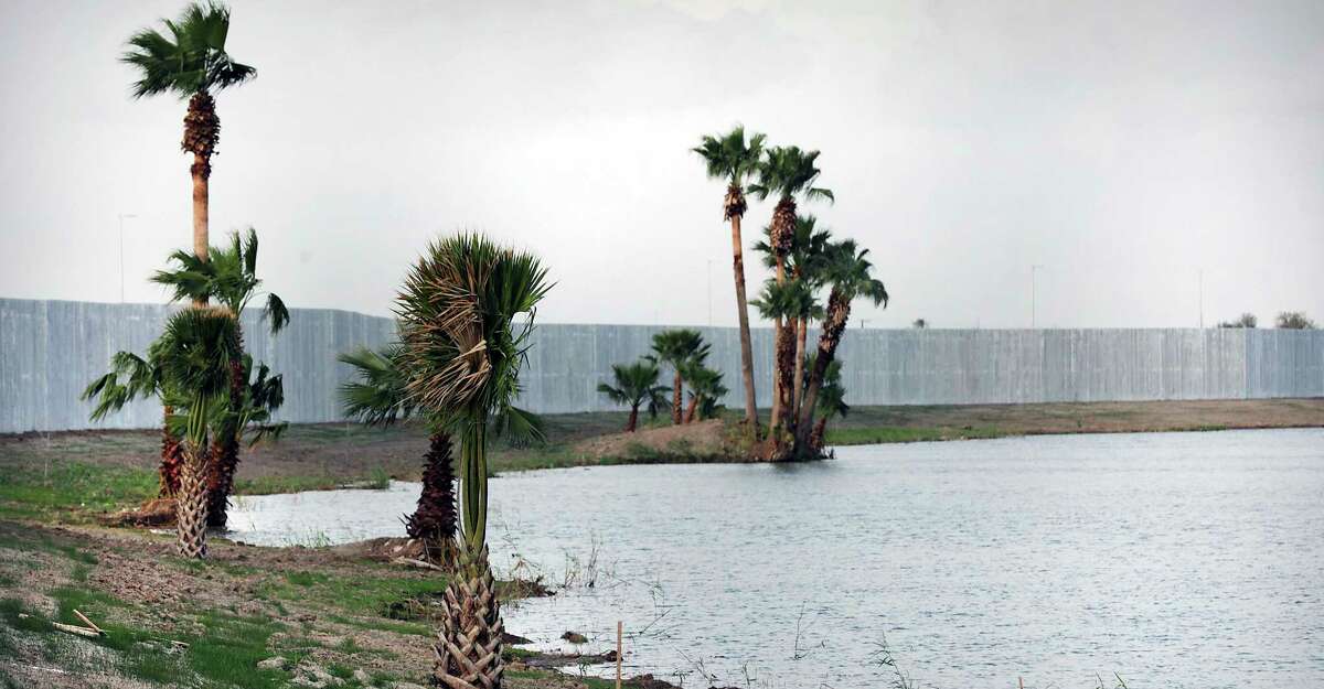 Palm trees were left along the banks of the Rio Grande where Fisher Sand and Gravel Co. is building 3 miles of border wall south of Mission, Texas.