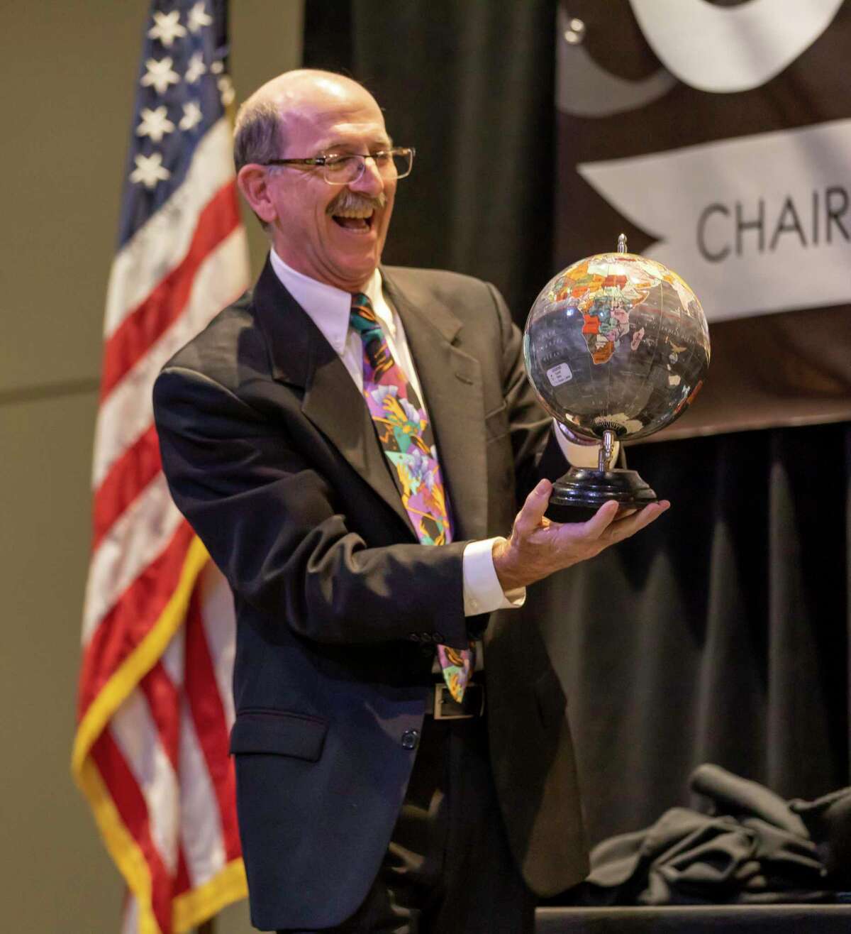 President of the Conroe/Lake Conroe Chamber of Commerce, Brian Bondy, presents a globe to outgoing chairman Brent Wunderlich as a thank you for his time as president at Lone Star Convention Center in Conroe, Thursday, Jan. 23, 2020.