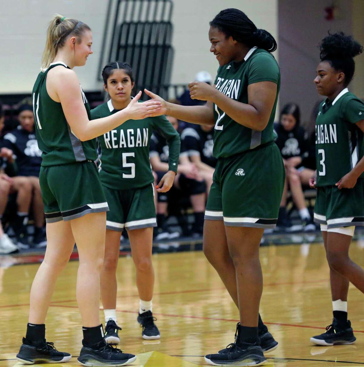 Samantha Wagner pals with Christeen Iwuala as she plays for Reagan against Lee at Littleton Gym on Jan.18, 2020.