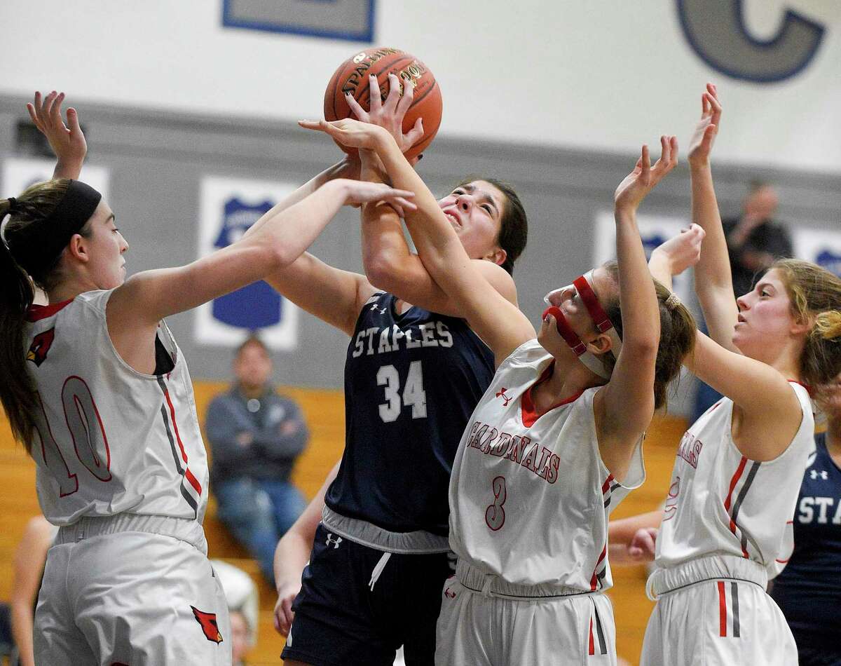 Staples Arianna Gerig puts up a shot against Greenwich's Bea Owens (10), Jordan Moses (3) and Julia Conforti (2) in the second half of an FCIAC girls basketball game at Staples High School on Jan. 24, 2020 in Westport, Connecticut. Staples defeated Greenwich 60-44.