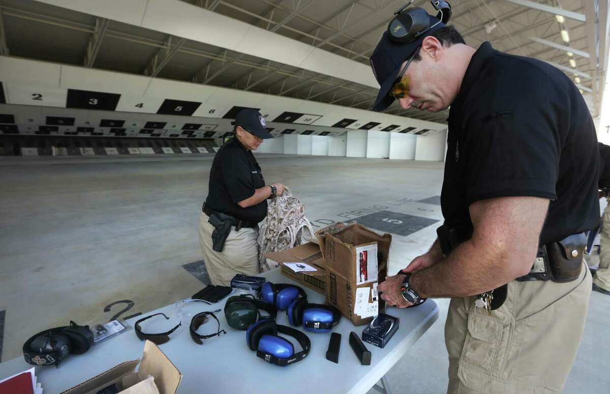 Members of the Texas A&M University San Antonio Police Department Susan Gonzales, left, and Jeff Grossman, right, prepare for shooting practice at the Bexar County Firing Range, Friday, August 30, 2013. In January 2020, the Galveston City Council rolled back regulations on firing ranges and gun shops after the Texas attorney general advised they violated state law.
