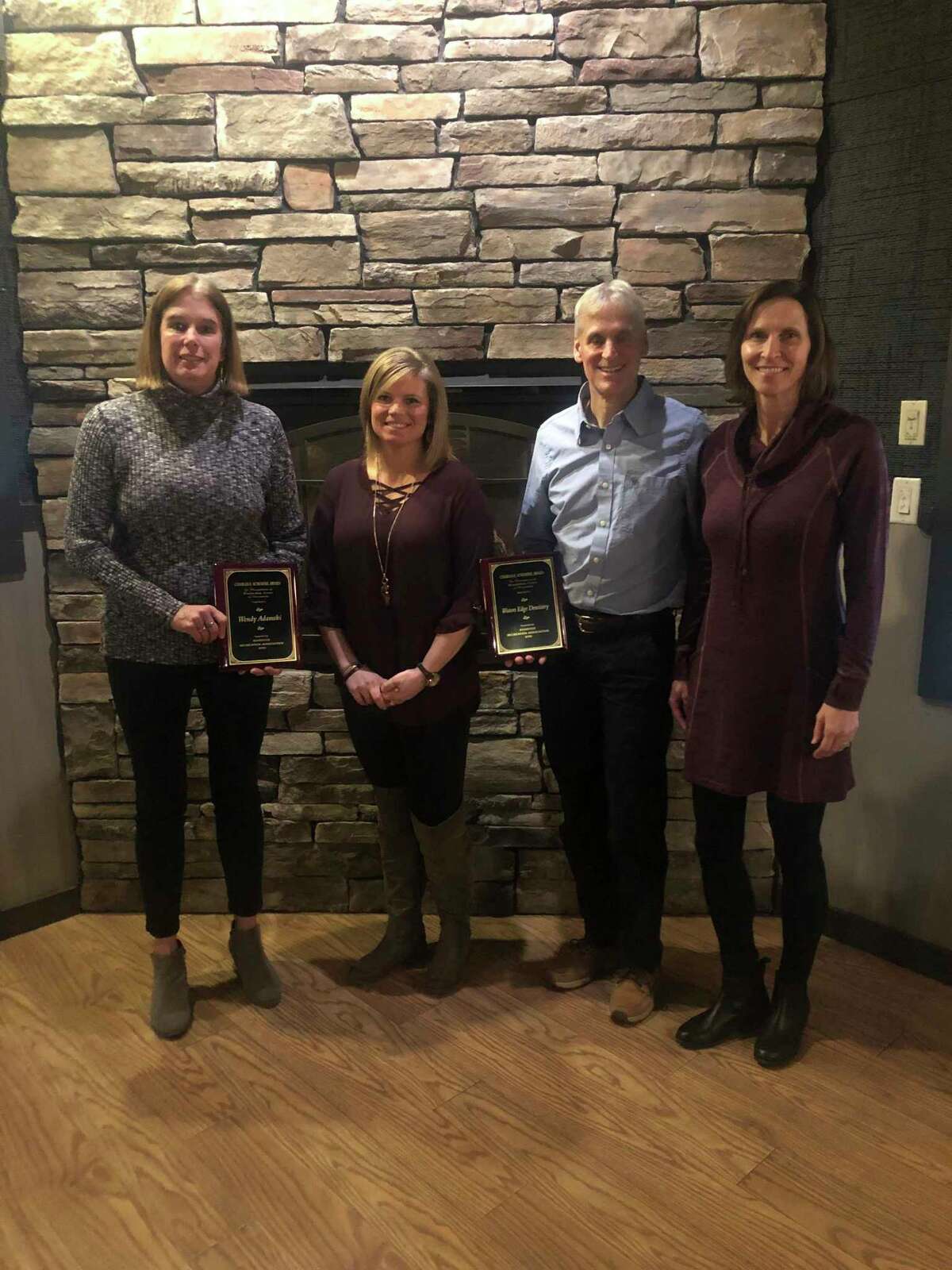 Each year, the Manistee Recreation Association presents the Charles E. Schoedel outstanding award to an individual and an organization. Pictured (from left to right) are Wendy Adamski (individual award winner), MRA executive director Stephanie Carpenter, and Geoff and Mary Paine of Water's Edge Dentistry (organization award winner). (Courtesy photo)