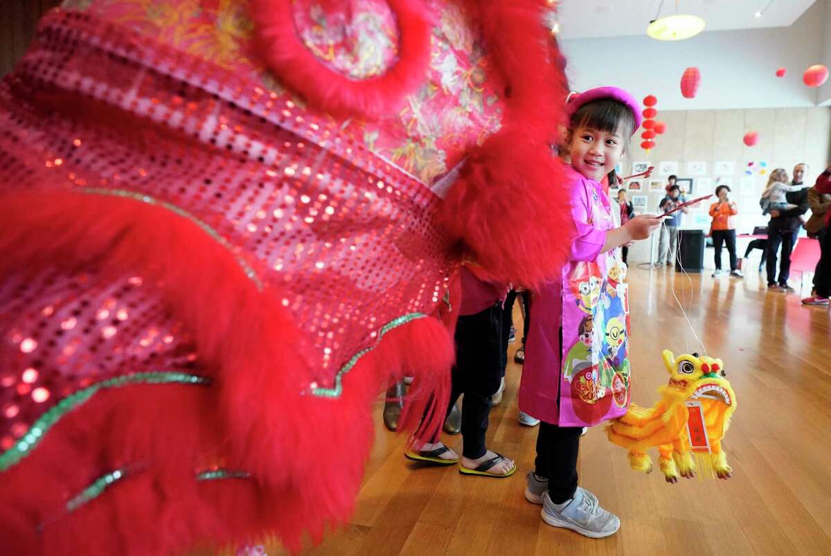 Jayden Cao, 5, watches a lion dance during the Lunar New Year Family Day event Saturday, Jan. 25, 2020, at the Asia Society Texas Center, 1370 Southmore Blvd., in Houston. As part of the Year of the Rat celebration, activities included performances, food, shopping and art and crafts.