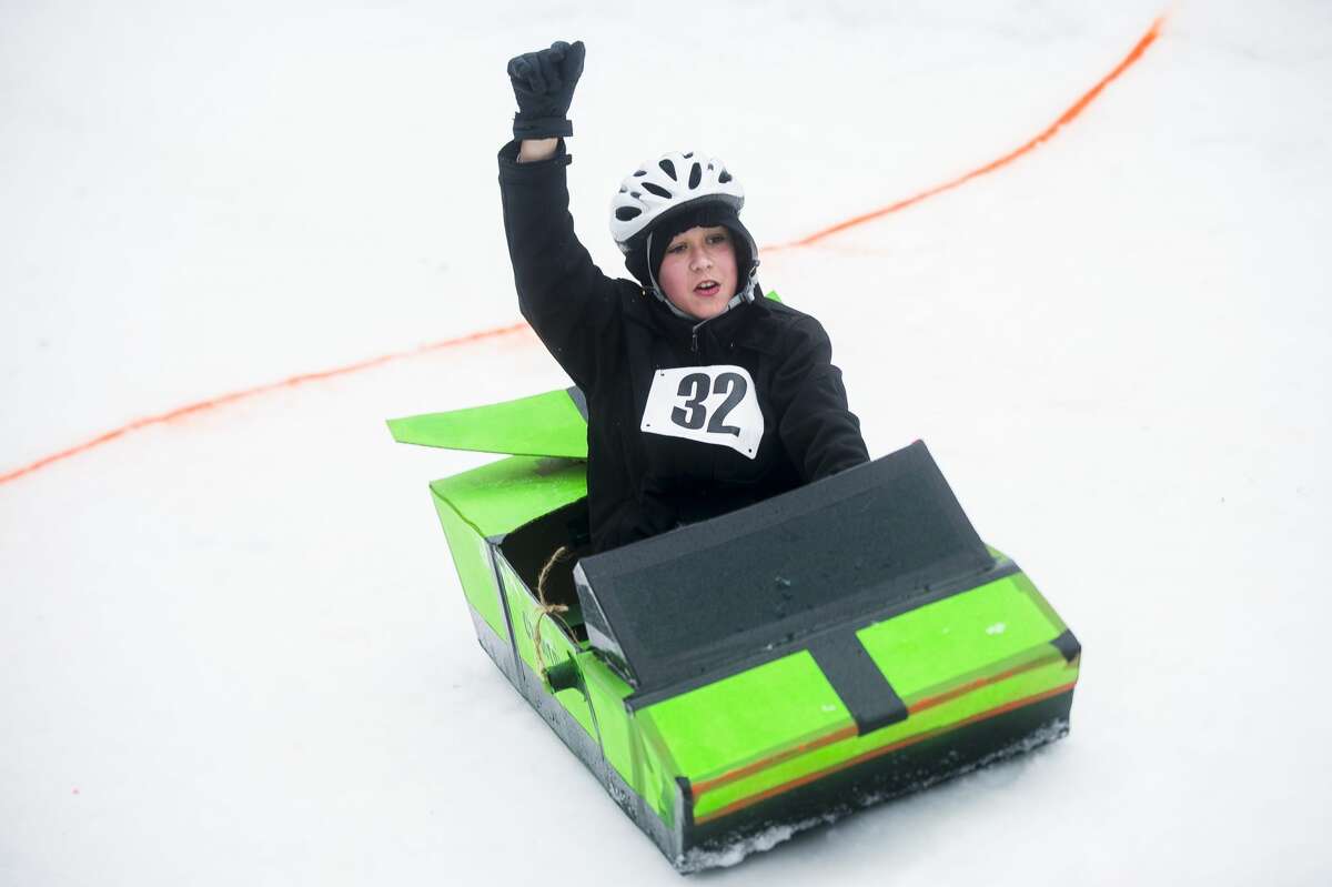Sledders race one another in one-of-a-kind sleds, constructed from cardboard, during the second annual cardboard sled races hosted by the City of Midland Parks and Recreation Saturday, Jan. 25, 2020 at City Forest. (Katy Kildee/kkildee@mdn.net)