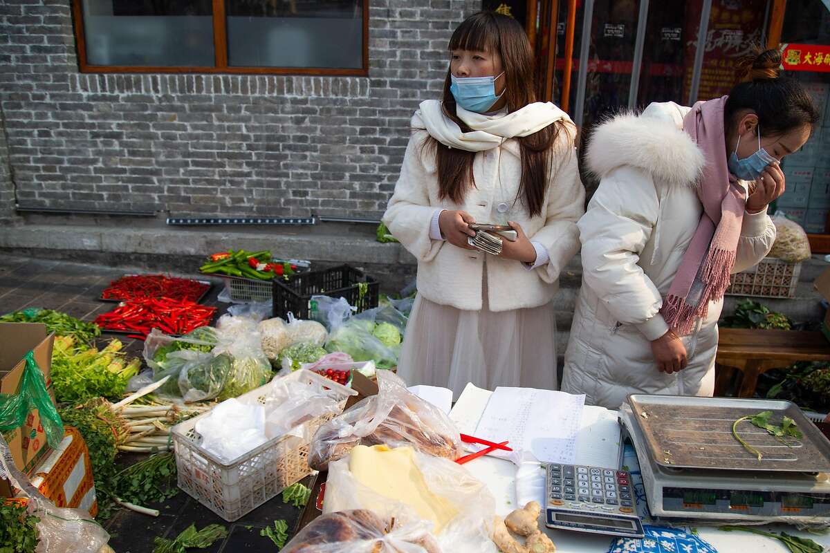 BEIJING, CHINA - JANUARY 26: People buy vegetables on the street outside a restaurant near Beixingtiao on January 26, 2020 in Beijing, China. The number of cases of coronavirus rose to 1,975 in mainland China on Sunday. Authorities tightened restrictions on travel and tourism this weekend after putting Wuhan, the capital of Hubei province, under quarantine on Thursday. The spread of the virus corresponds with the first days of the Spring Festival, which is one of the biggest domestic travel weeks of the year in China. Popular tourism landmarks in Beijing including the Forbidden City, Badaling Great Wall, and The Palace Museum were closed to the public starting Saturday. The Beijing Municipal Education Commission announced it will delay reopening schools from kindergarten to university. The death toll on Sunday rose to 56. The majority of fatalities are in Wuhan where the first cases of the virus were reported last month. (Photo by Betsy Joles/Getty Images)