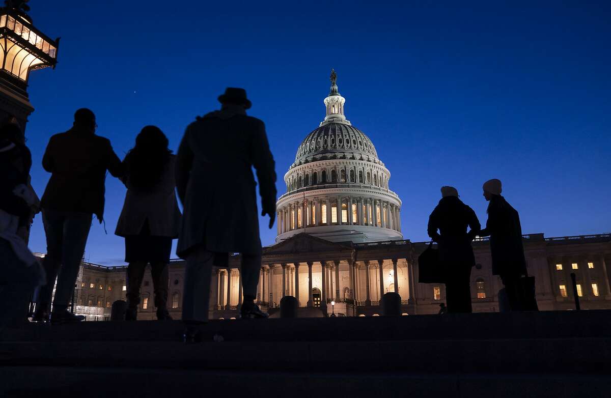 FILE - In this Jan. 22, 2020 file photo, night falls on the Capitol, in Washington during the impeachment trial of President Donald Trump. For all the gravity of a presidential impeachment trial, Americans don’t seem to be giving it much weight. Web traffic and TV ratings tell a similar story, with public interest seeming to flag after the House voted last month to impeach a president for only the third time in U.S. history. (AP Photo/J. Scott Applewhite, File)