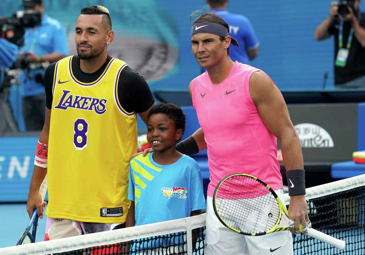 Australia's Nick Kyrgios, left, poses for a photo with Rafael Nadal, wearing a shirt as a tribute to Kobe Bryant ahead of his fourth round singles match at the Australian Open tennis championship in Melbourne, Australia, Monday.