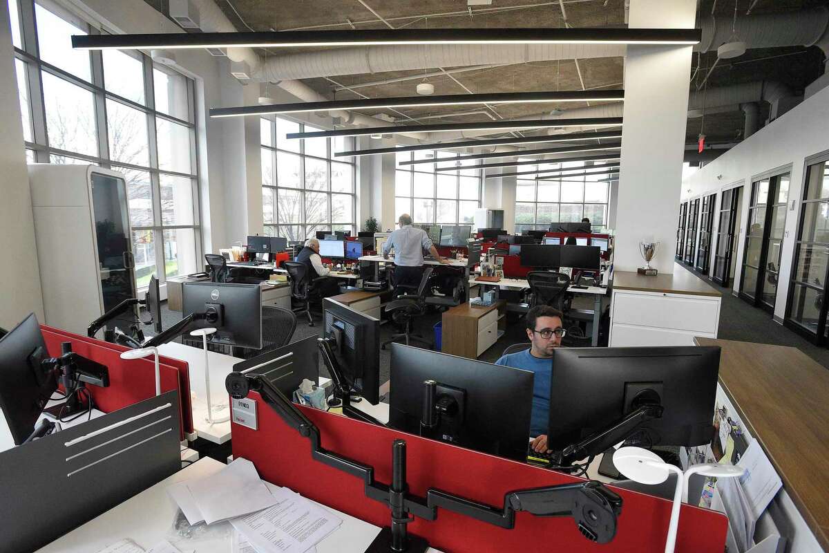 Employees work in commercial real estate firm JLL’s new offices at 1 Station Place in downtown Stamford, Conn., on Jan. 16, 2020.