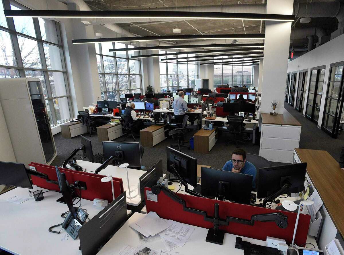 Employees work in commercial real estate firm JLL’s new offices at 1 Station Place in downtown Stamford, Conn., on Jan. 16, 2020.