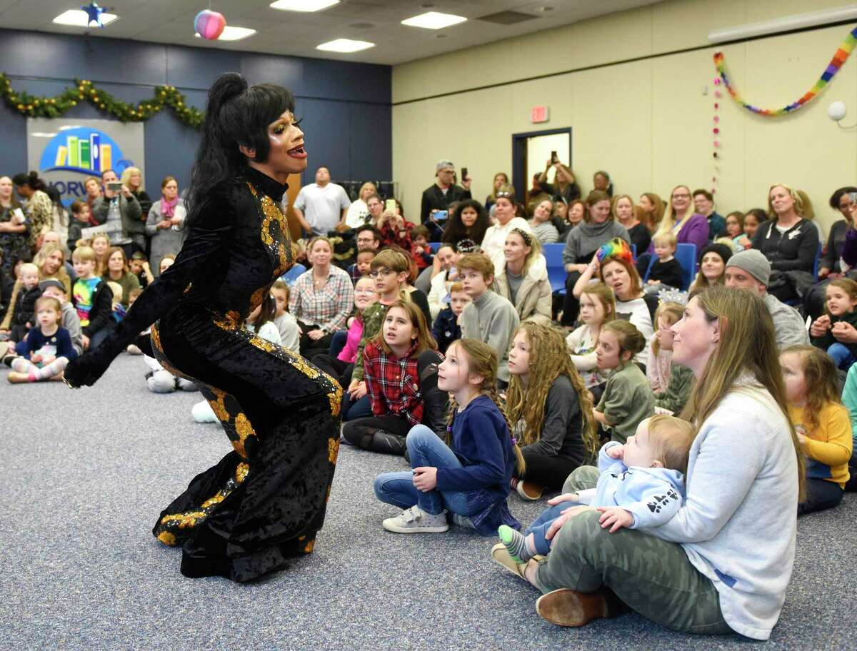 Drag queen Robin Fierce performs a lip-sync of "When You Believe" at Drag Queen Storytime, presented by Troupe429, at Norwalk Public Library in Norwalk, Conn. Sunday, Jan. 26, 2020. Three drag queens and one drag king read stories to a packed house of children and parents, followed by a lip-sync performance of "When You Believe." A Christian group protested the event outside saying prayers and holding signs including "defend children's innocence" and "bearded ladies belong in a circus."