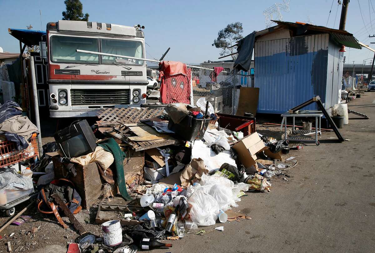 Some trash and debris remains at a homeless encampment in front of the Home Depot near High Street in Oakland, Calif. on Tuesday, Nov. 5, 2019. Oakland officials have recently cleared out about 250 tons of debris from the site but another 50 tons remain.