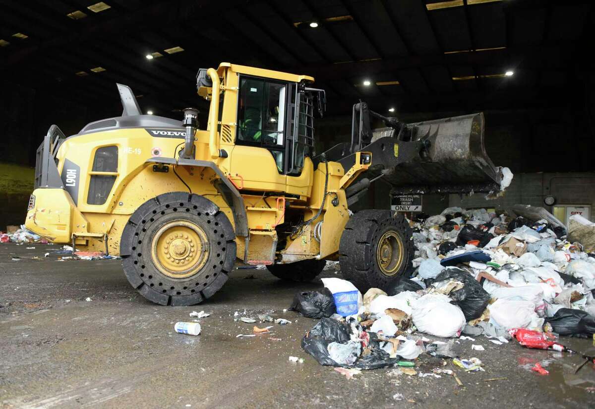 Equipment compacts trash in the commercial dumping bay at the Holly Hill Transfer Station in Greenwich, Conn. Monday, Jan. 27, 2020.