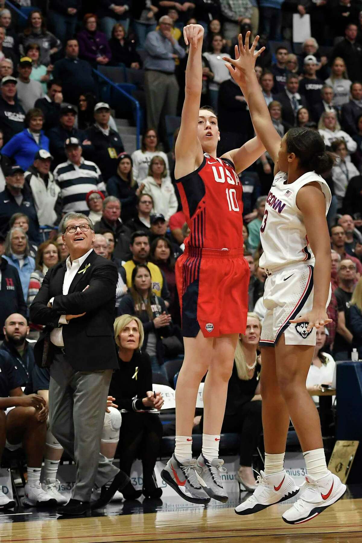 Connecticut head coach Geno Auriemma watches a shot attempt by United States' Breanna Stewart, center, as Connecticut's Megan Walker, right, defends, in the first half of an exhibition basketball game, Monday, Jan. 27, 2020, in Hartford, Conn. (AP Photo/Jessica Hill)