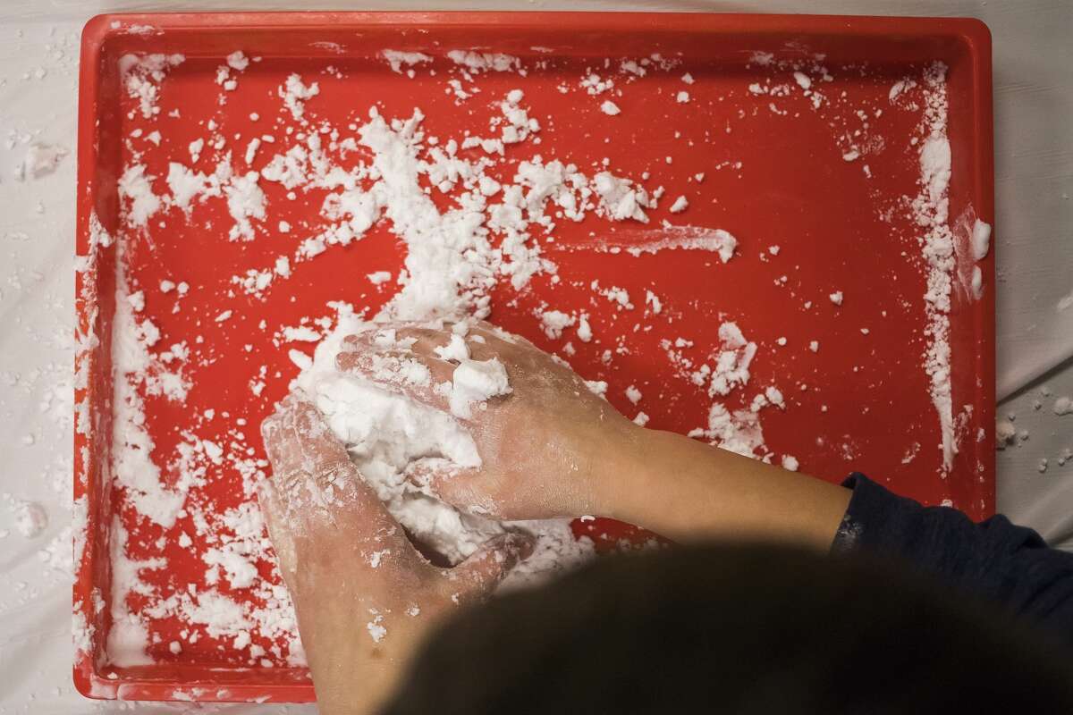 Children use baking soda and shaving cream to make artificial snow during a craft event Wednesday, Jan. 15, 2020 at the Auburn Area Branch Library in Auburn. (Katy Kildee/kkildee@mdn.net)