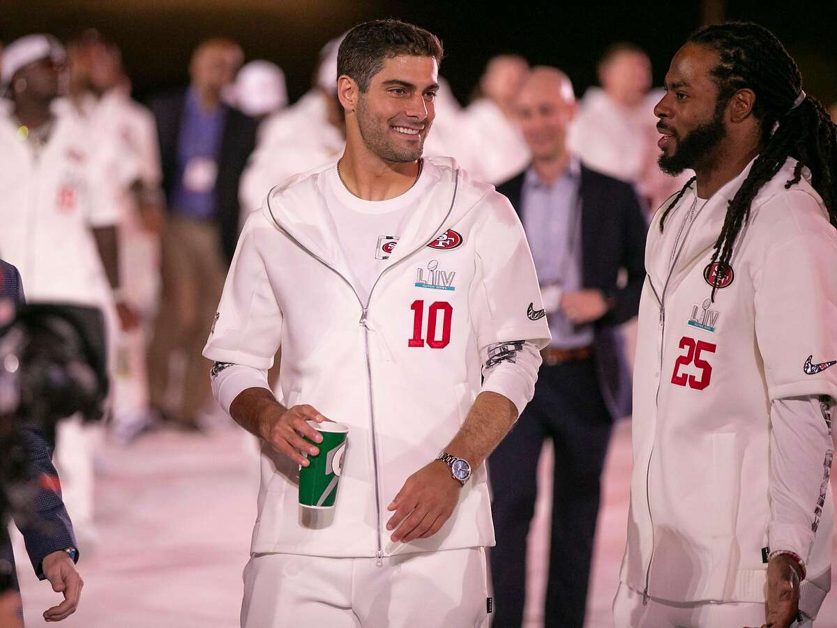 San Francisco 49ers quarterback Jimmy Garoppolo (10) and San Francisco 49ers cornerback Richard Sherman (25) arrive for Super Bowl Opening Night presented by BOLT24, the national kick off for Super Bowl LIV festivities at Marlins Park in Miami, Fla. (Al Diaz/MIami Herald/TNS)