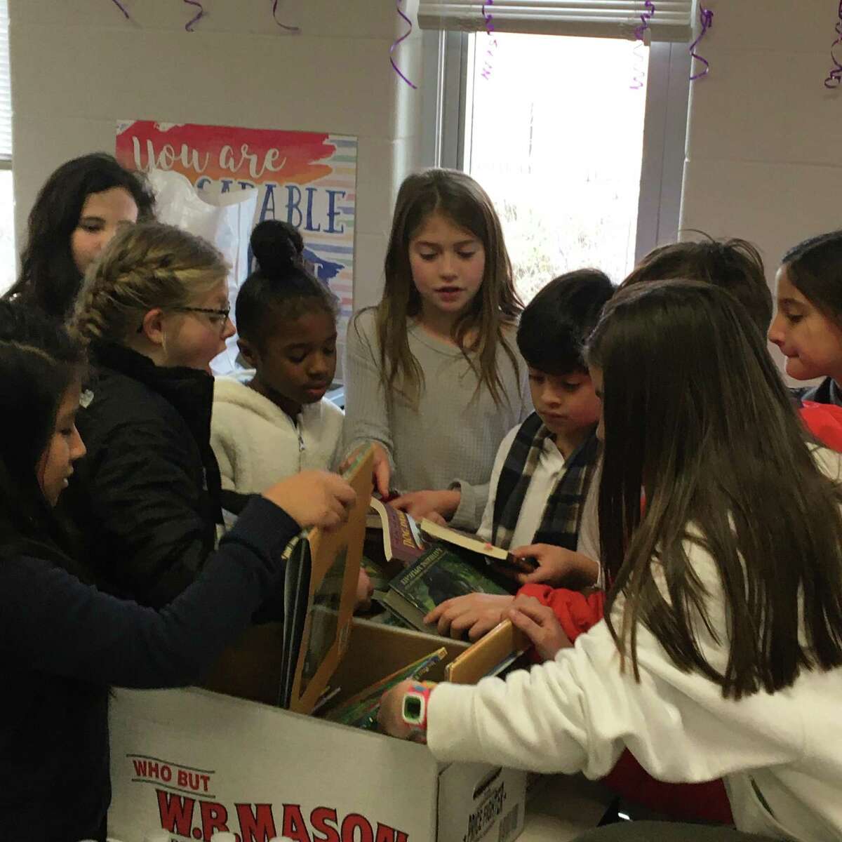 South School students, families and staff in New Canaan recently came together and packed more than 700 meal bags for the Filling In The Blanks warehouse. The students also supported a Holiday Book Drive for Geraldine W. Johnson School in Bridgeport.