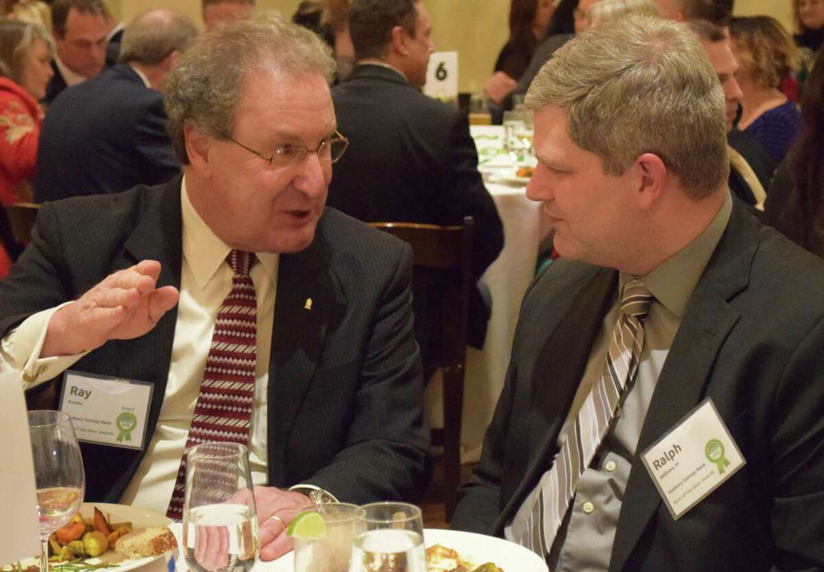 Local businessmen Ray Kostka, left, and Ralph Williams share conversation during dinner.