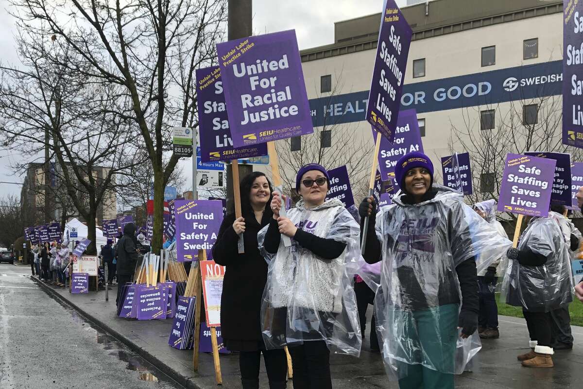 Swedish Medical Center nurses and other workers picket outside the hospital's campus in the Ballard neighborhood of Seattle as they began a three-day strike Tuesday, Jan. 28, 2020, over staffing levels, wages and other issues. The hospital system closed two of its seven emergency departments and brought in replacement workers in response to the strike. (AP Photo/Gene Johnson)