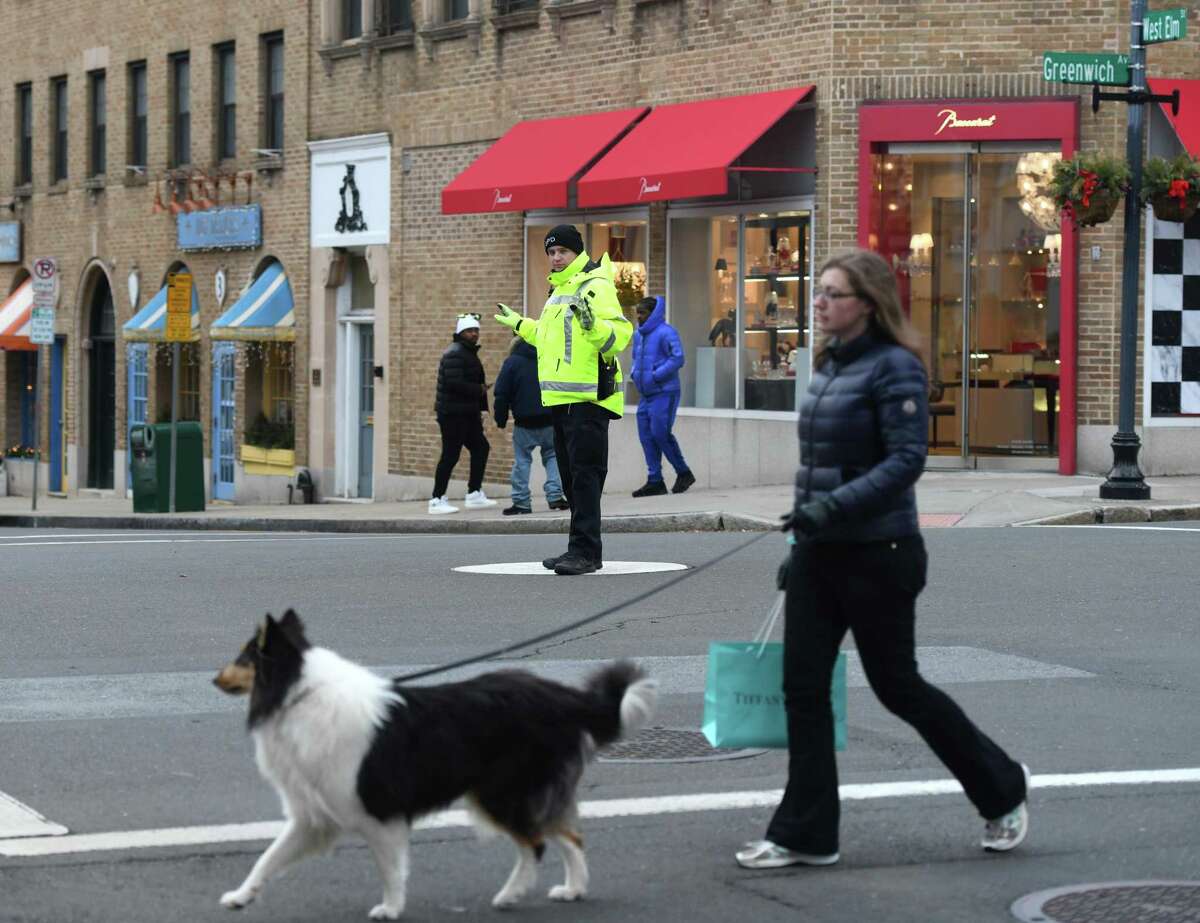 A Greenwich Police Officer directs traffic at the intersection of Greenwich Avenue and Elm Street in Greenwich, Conn. Tuesday, Jan. 28, 2020. First Selectman Fred Camillo proposed the elimination of the longtime tradition of traffic cops along Greenwich Avenue, which he estimated a cost savings of more than $250,000 per year.