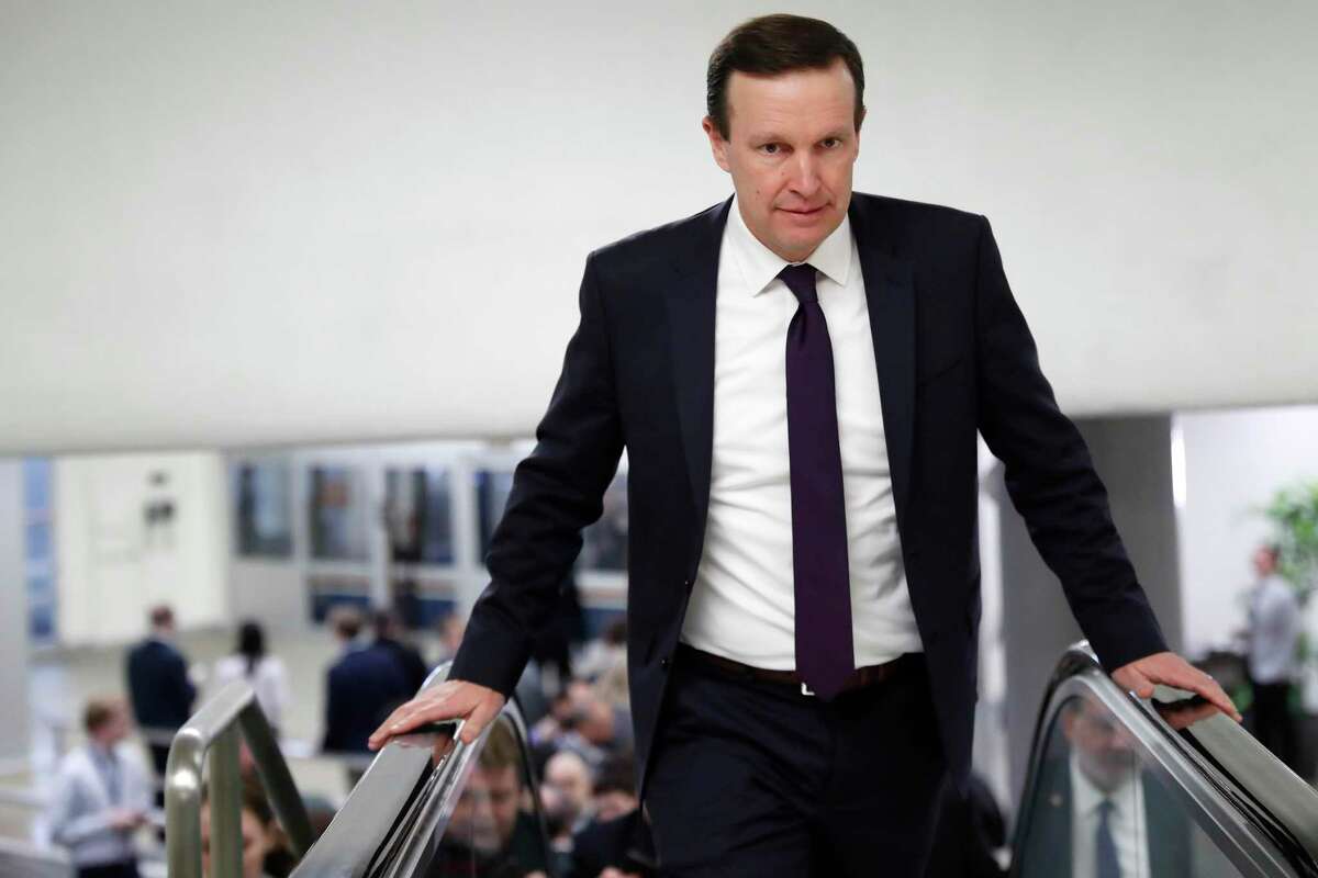 Sen. Chris Murphy, D-Conn., takes an escalator as he heads to attend the impeachment trial of President Donald Trump on charges of abuse of power and obstruction of Congress, Wednesday, Jan. 22, 2020, on Capitol Hill in Washington. (AP Photo/ Jacquelyn Martin)
