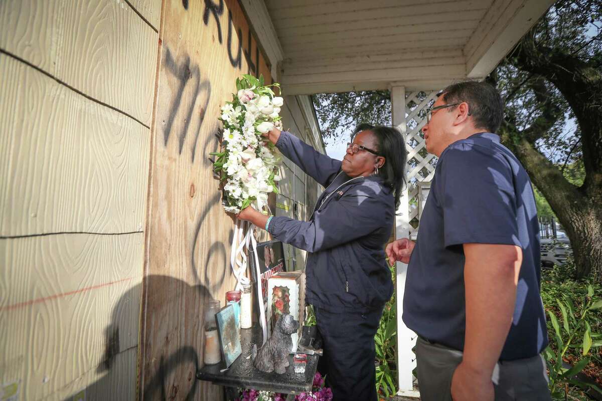 Former Houston Police Officer Kathy Swilley and We The People Founder Hai Bui attempt to hang a wreath on a house at 7815 Harding Street before a small vigil on anniversary of botched raid Tuesday, Jan. 28, 2020, in Houston.