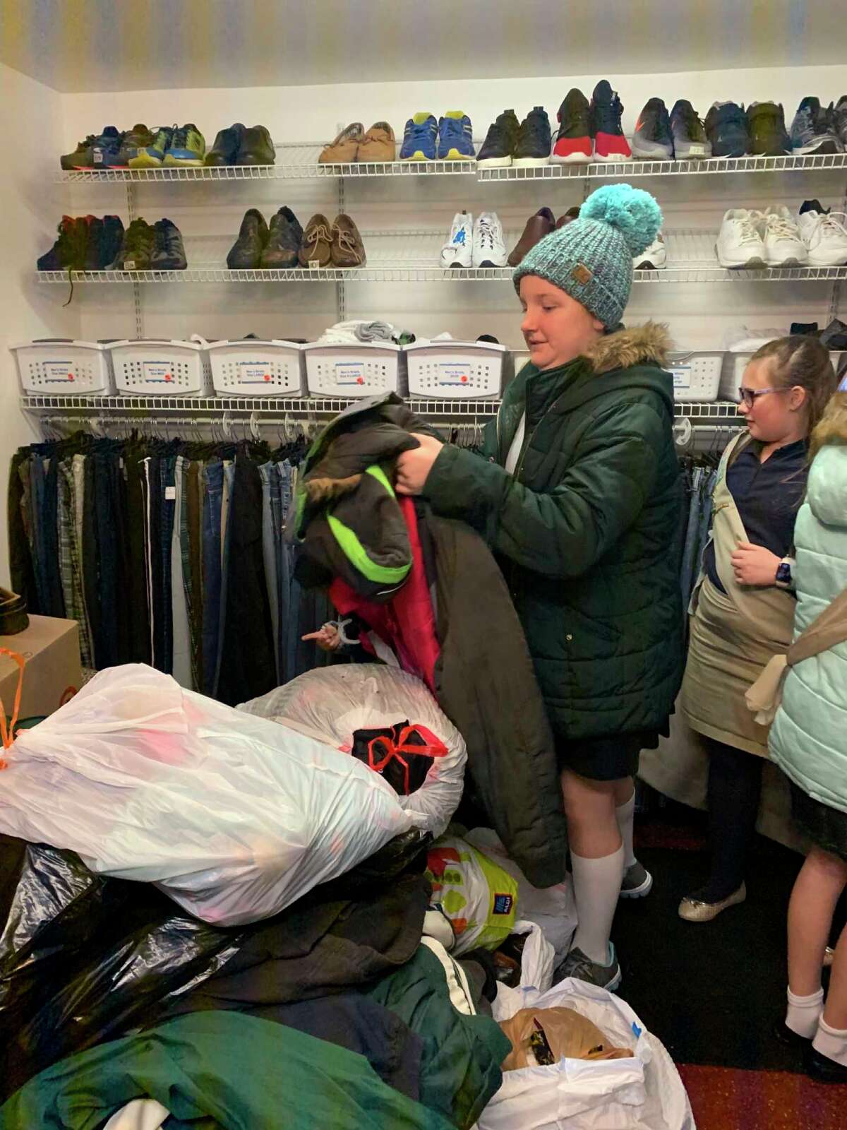 Girl Scout troop donates and tours Midland's Open Door