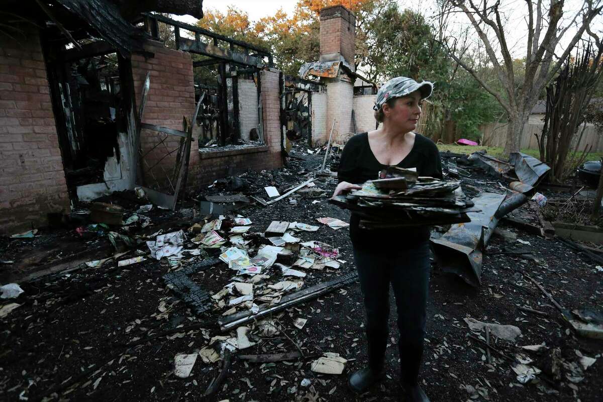 Becky King takes one last look before leaving for the day with salvaged belongings from her mother's home that was destroyed from a lightning-induced fire on Friday, Jan. 24, 2020. King's mother, Margie Miller, 85, managed to escape after lightning struck the house and set fire to her home on Jan. 11 following one of the first major storms of the year. Miller, who was immersed in local theater for the past 40 years, lost not only precious family heirlooms and keepsakes, but a major collection of costumes and memorabilia of her children who all played an important roles in local theater. Miller lived on fixed income and recovery from the fire-damaged home has been made more difficult since she did not have insurance on her home. King and her siblings have started a Go Fund Me account to raise finances to help with the loss.