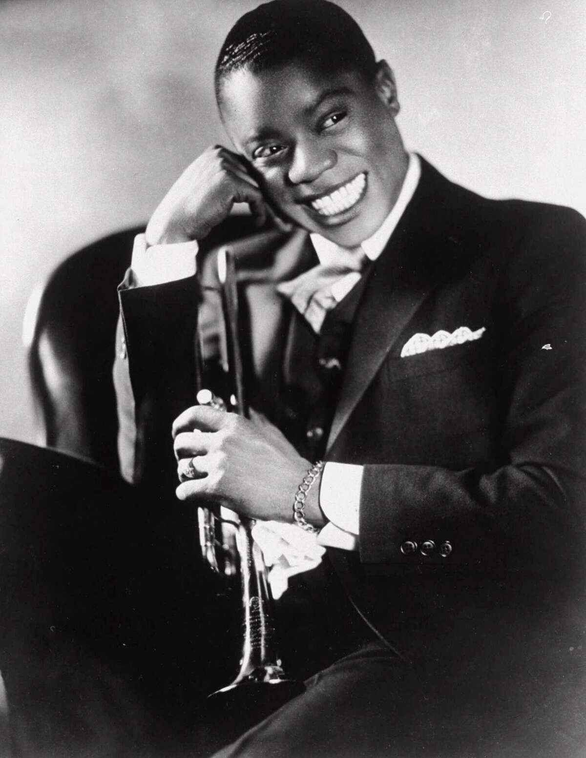 Louis Armstrong displays his broad smile in this 1932 file photo, made in Chicago to promote his first European tour. Armstrong’s early career will be the subject of a talk at Wilton Library on Sunday, Feb. 9.