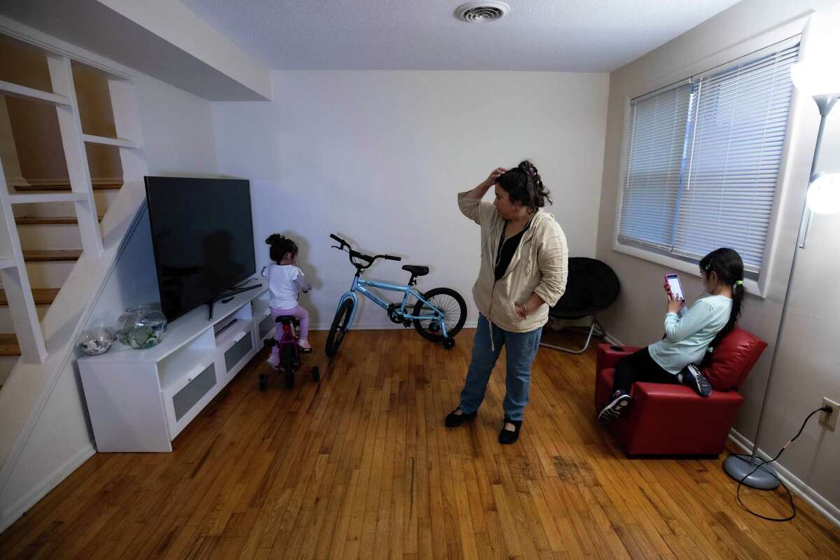 Tania Rodriguez, 48, with her daughters Charlotte and Caroline in their new West Haven home.