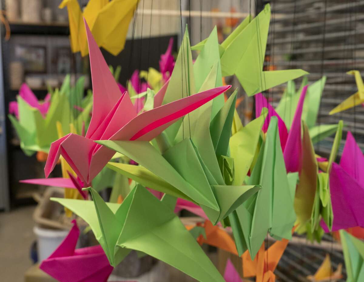Hundreds of origami birds are made with glow-in-the-dark paper 01/29/2020 for one of the pieces that will be in the Glowtastic exhibit. Tim Fischer/Reporter-Telegram