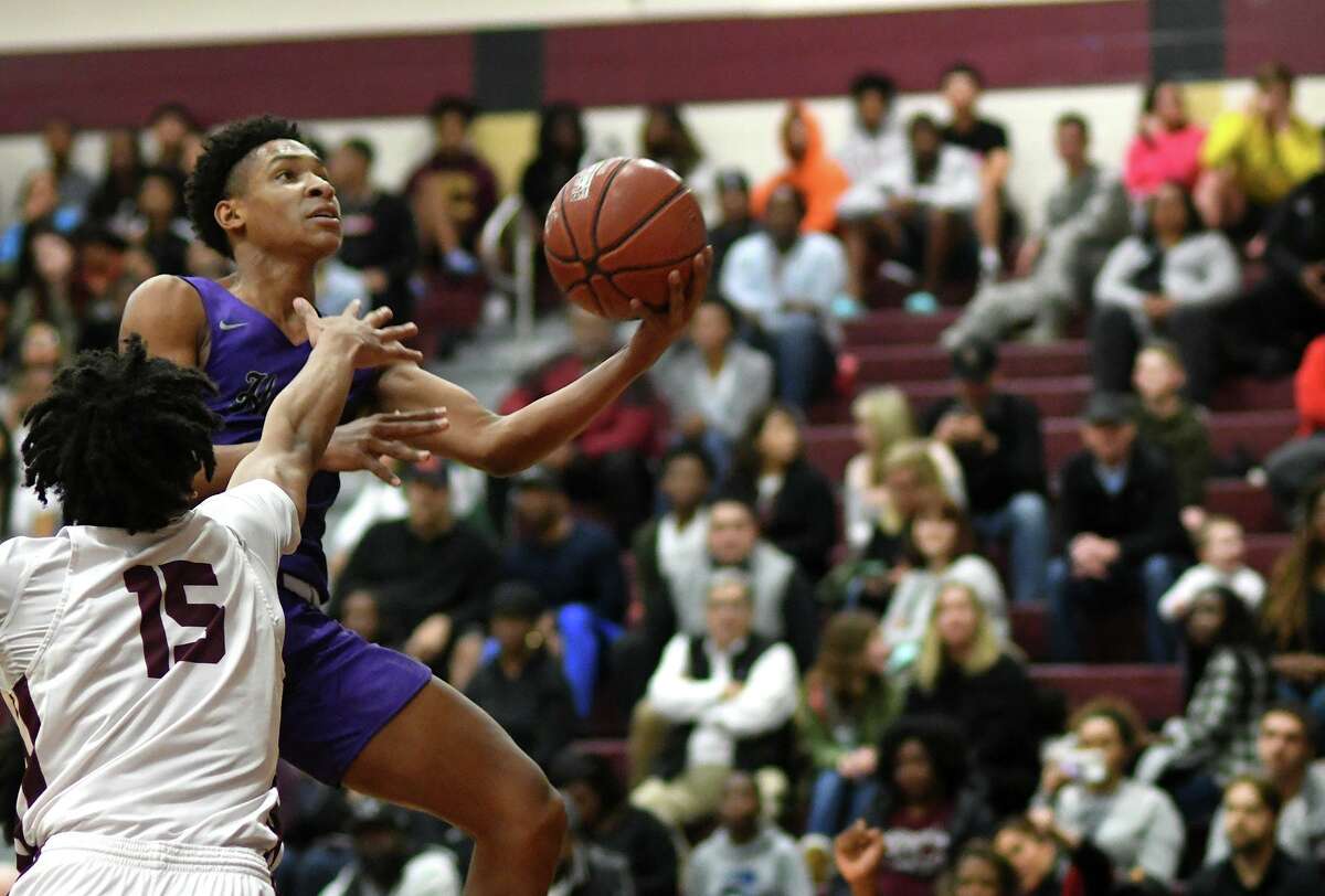 Humble junior guard Kaeden Sims, right, drives to the hoop against Summer Creek junior forward Reyce Allen (15) in the first quarter of their District 22-6A matchup at SCHS on January 28, 2020.