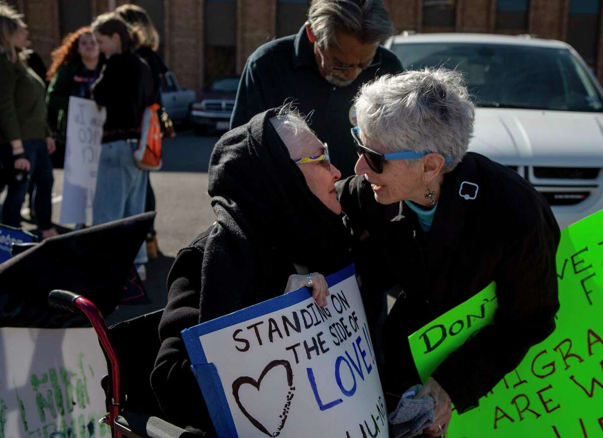 Peggy Ornelas of the Interfaith Welcome Coalition, left, embraces Sister Sharon Altendorf during a protest of the Trump administration Migrant Protection Protocols policy outside the San Antonio Immigration Court on Jan. 29, 2020. Wednesday marks one year since the Migrant Protection Protocols policy, also known as "Remain in Mexico," was implemented. Under the program asylum-seekers are sent to the Northern Mexico border to await their court hearings.
