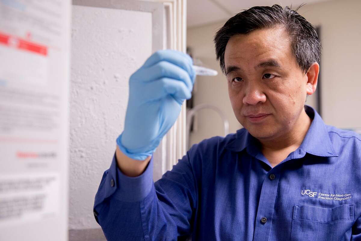 Dr. Charles Chiu takes out a sample of an infectious disease stored in the freezers in the lab at the UCSF Mission Bay campus in San Francisco, Calif. Wednesday, January 29, 2020. Chiu, an associate professor and director of a center that studies emerging pathogens, has partnered with San Francisco company Mammoth Biosciences to create a simple test that could diagnose the new coronavirus within several hours.