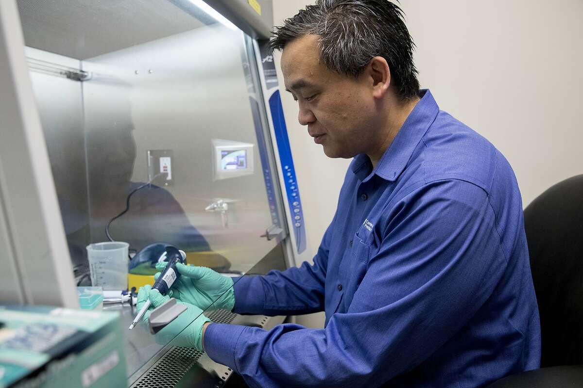 Dr. Charles Chiu demonstrates how he and his team prepare samples of infectious pathogens while in the lab at the UCSF Mission Bay campus in San Francisco, Calif. Wednesday, January 29, 2020. Chiu an associate professor and director of a center that studies emerging pathogens, has partnered with San Francisco company Mammoth Biosciences to create a simple test that could diagnose the new coronavirus within several hours.