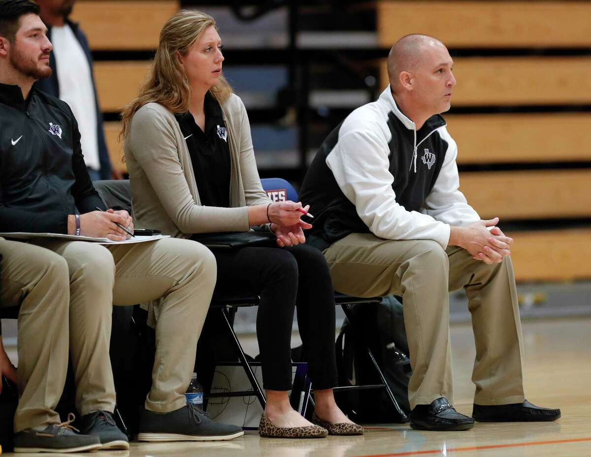 Willis first assistant coach Megan Storms, left, is seen alongside her husband and head coach, Michael, during a District 20-5A high school basketball game at Grand Oaks High School, Tuesday, Jan. 21, 2020, in Spring.