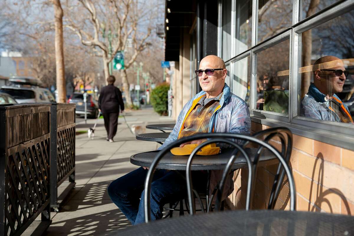 Randy Lyman sits outside of Perch, a local coffee shop he often frequents in Oakland, Calif. on Monday, January 27, 2020. Just across the street is the corner where Lyman was robbed at gun point just after midnight on January 18 at the corner of Grand Avenue and Bellevue Avenue in Oakland. After being punched in the face and held at gunpoint the robbers took both his wallet and phone before leaving in a nearby car. Lyman's robbery was one of many that have been occurring in Oakland involving getaway cars.
