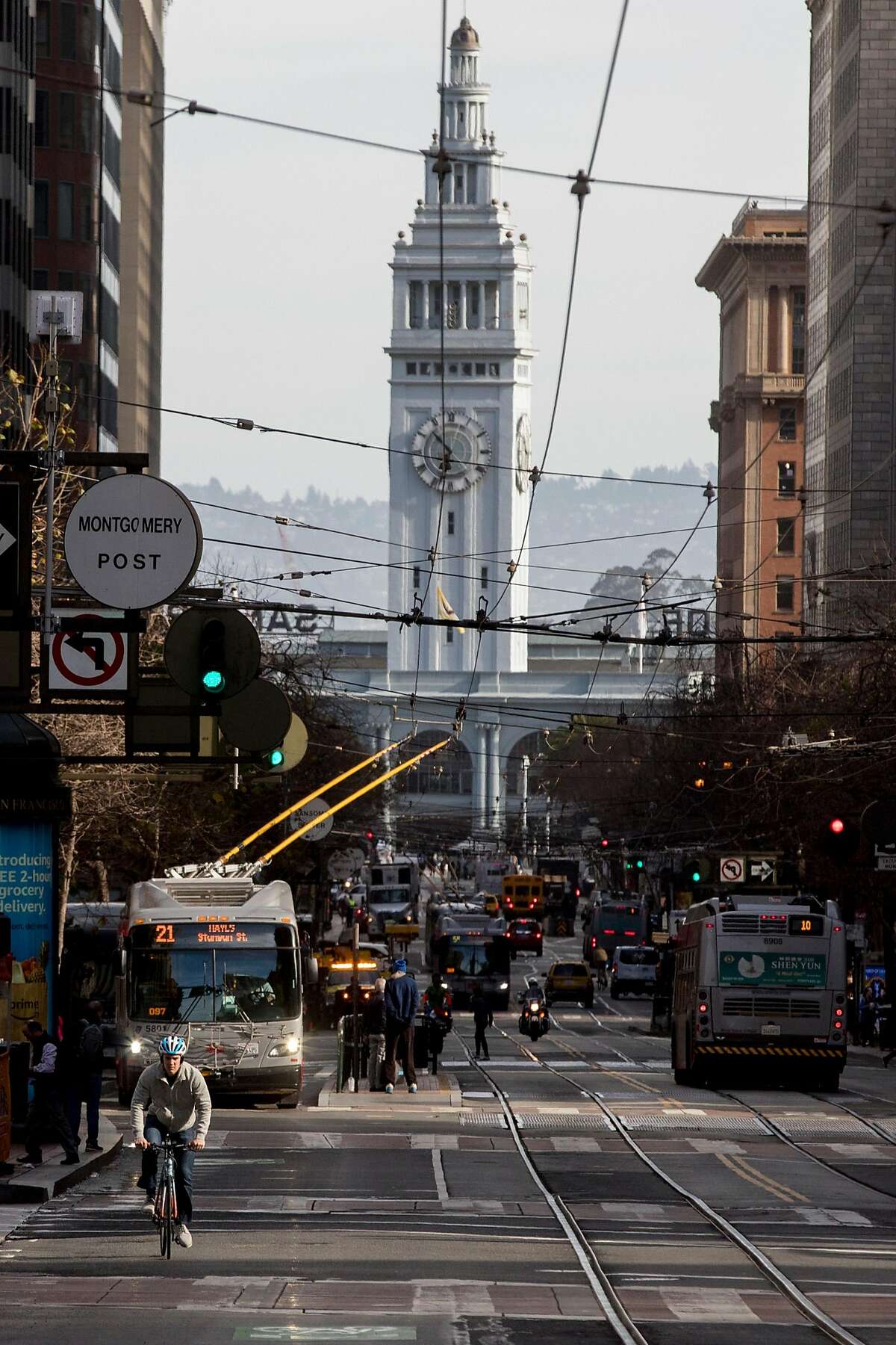 Buses and cyclists move down Market Street in San Francisco, Calif. Wednesday, January 29, 2020. Beginning January 29, private vehicles will be banned from driving along Market Street between Steuart and 10th streets, leaving it free for cyclists, pedestrians and public transit vehicles.
