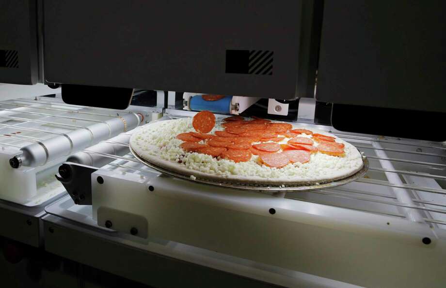 Picnic's pizza-making robot makes a pizza at a food vendor's booth during the CES tech show in Las Vegas. Photo: John Locher, STF / Associated Press / Copyright 2020 The Associated Press. All rights reserved.