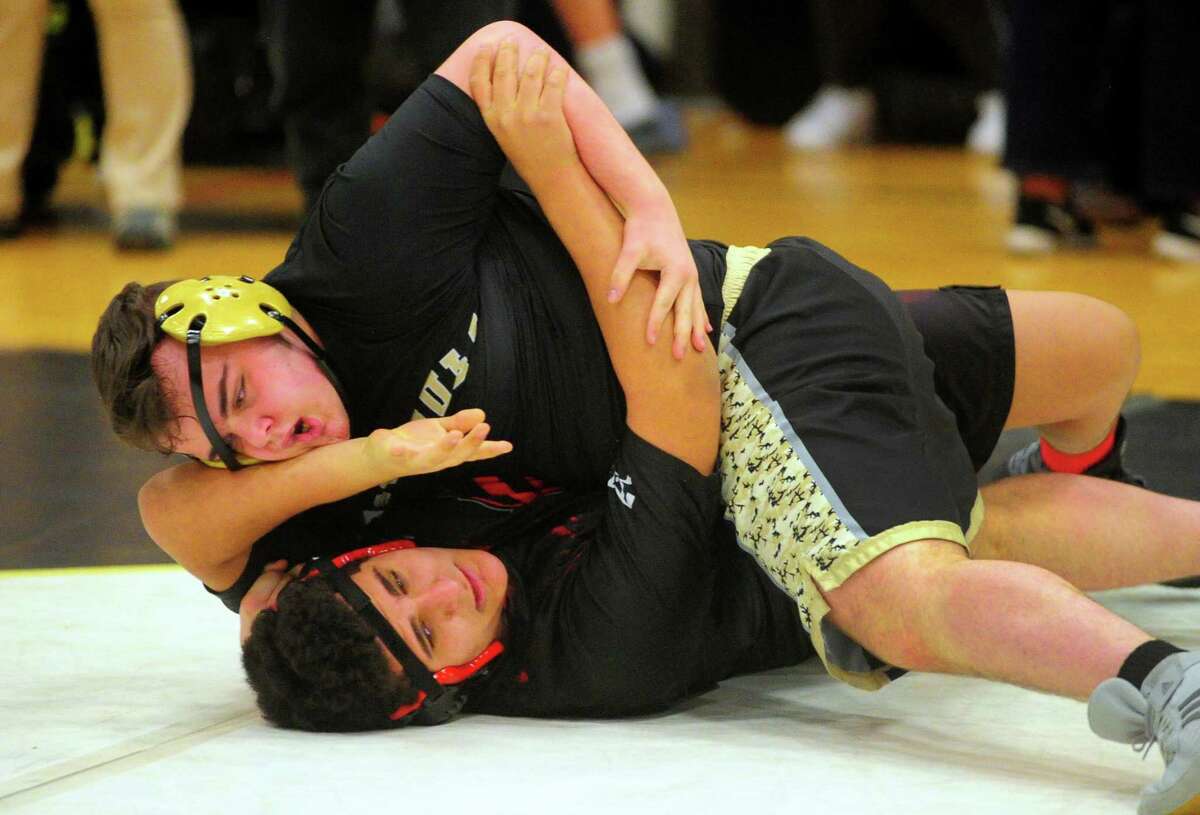 Trumbull's Abrahim Sakakini works to pin Fairfield Warde's Wyatt Morgan during high school wrestling action in Trumbull, Conn., on Wednesday Jan. 29, 2020.