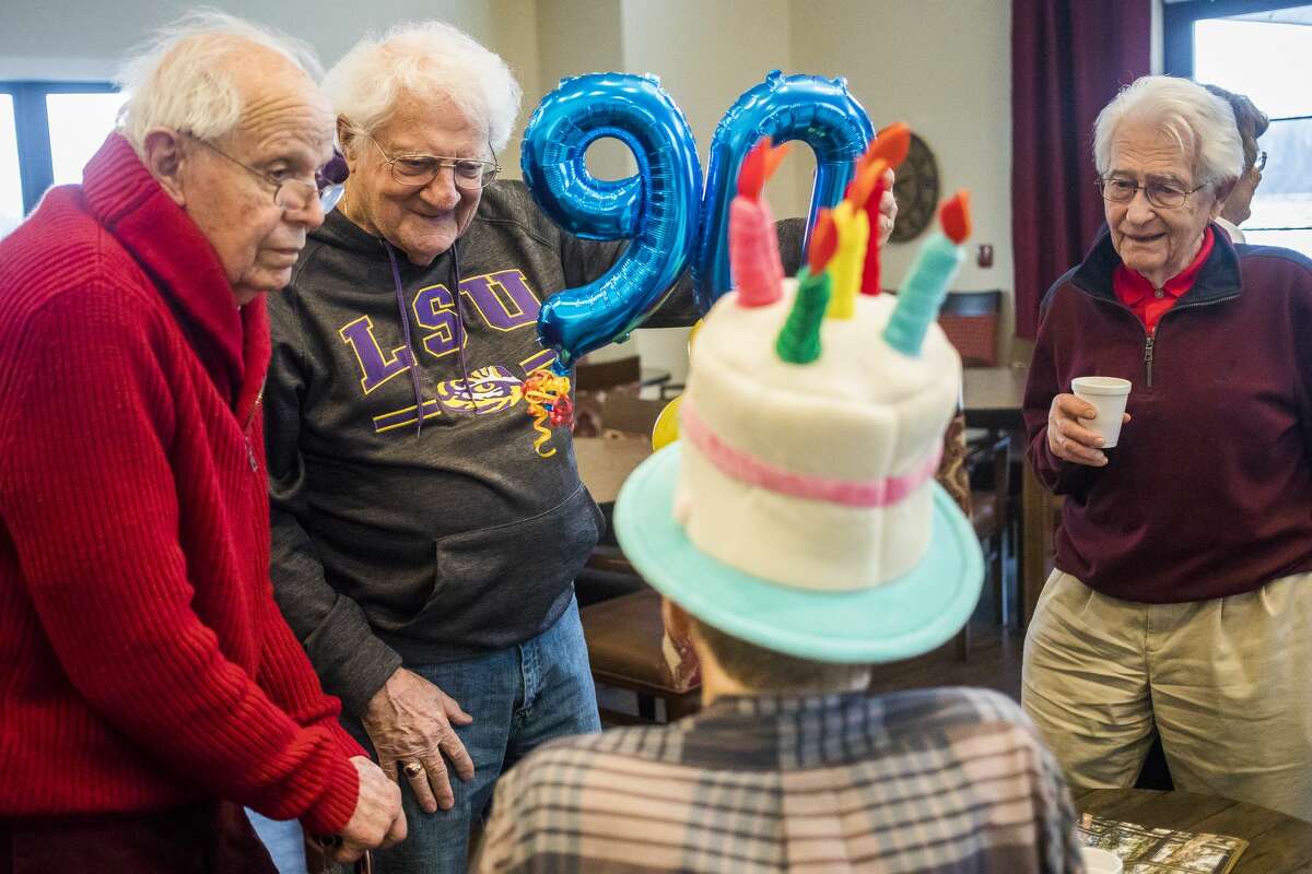 Bob Lee, center, chats with Richard Heiny, bottom, during a 90th birthday party for Heiny, which was organized as part of a local birthday club, Wednesday, Jan. 15, 2020 at Primrose Retirement Community. (Katy Kildee/kkildee@mdn.net)