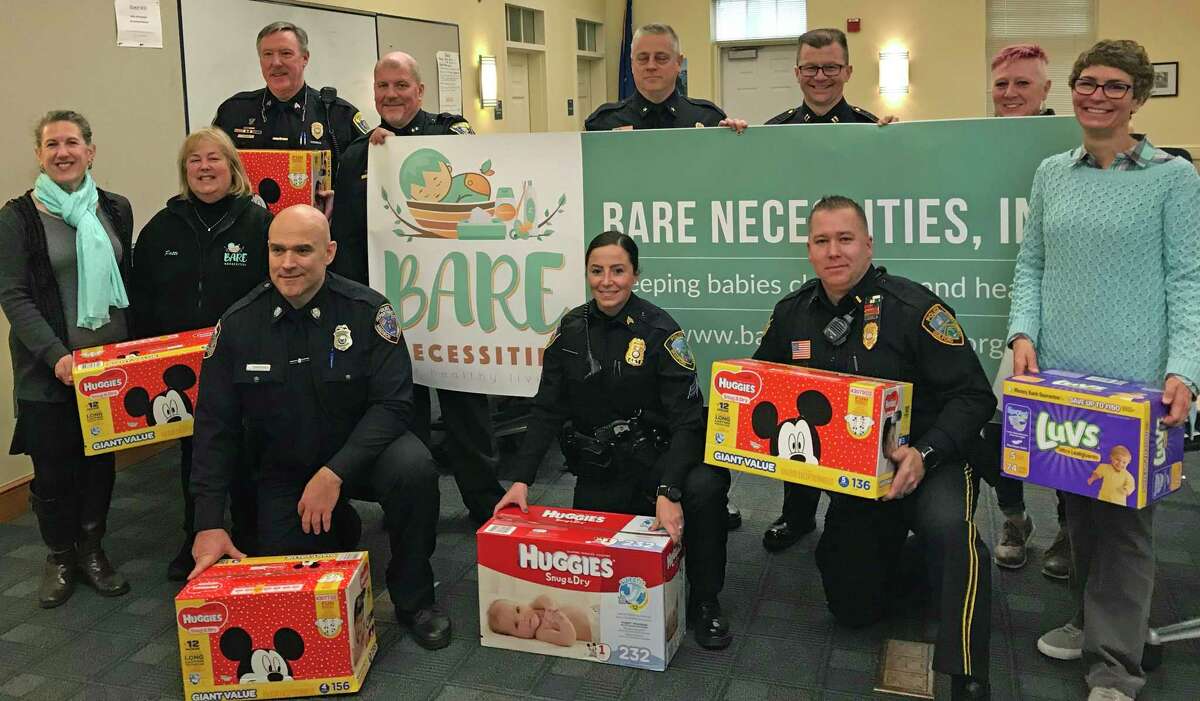 Police officials from Clinton, Guilford, madison and Branford are picturd with staff from Bare Necessities showing off the donations from 2019’s diaper drive.