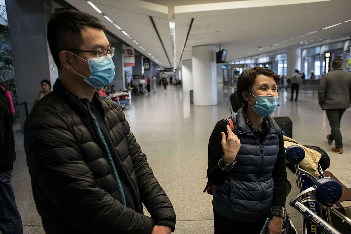 From left, Simon Wu and Michelle Du talk about the tests they had to go through while flying through China. The two said they didn't have any at San Francisco Airport's international terminal on January 30, 2020 in San Francisco, Calif. Airlines are cancelling some flights to China because of concerns over the coronavirus.