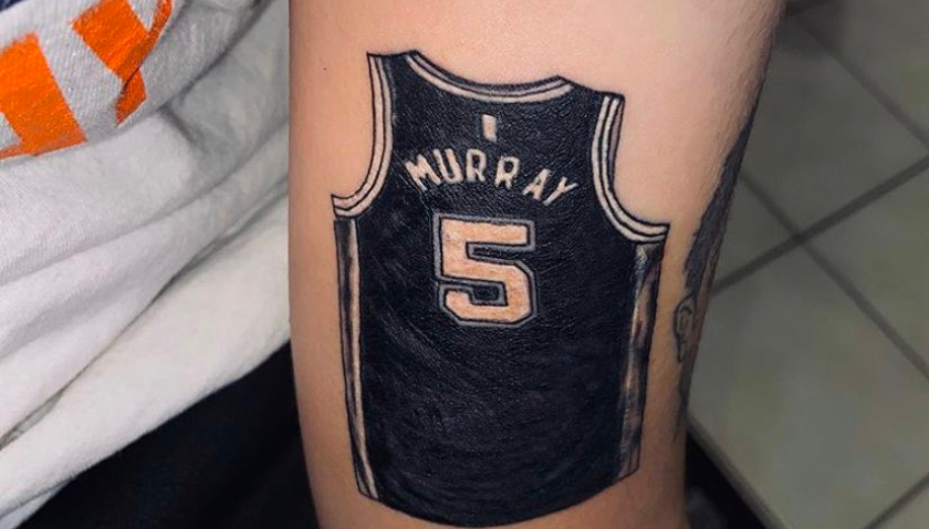 Dejounte Murray meets Spurs fan who got a tattoo of his jersey.